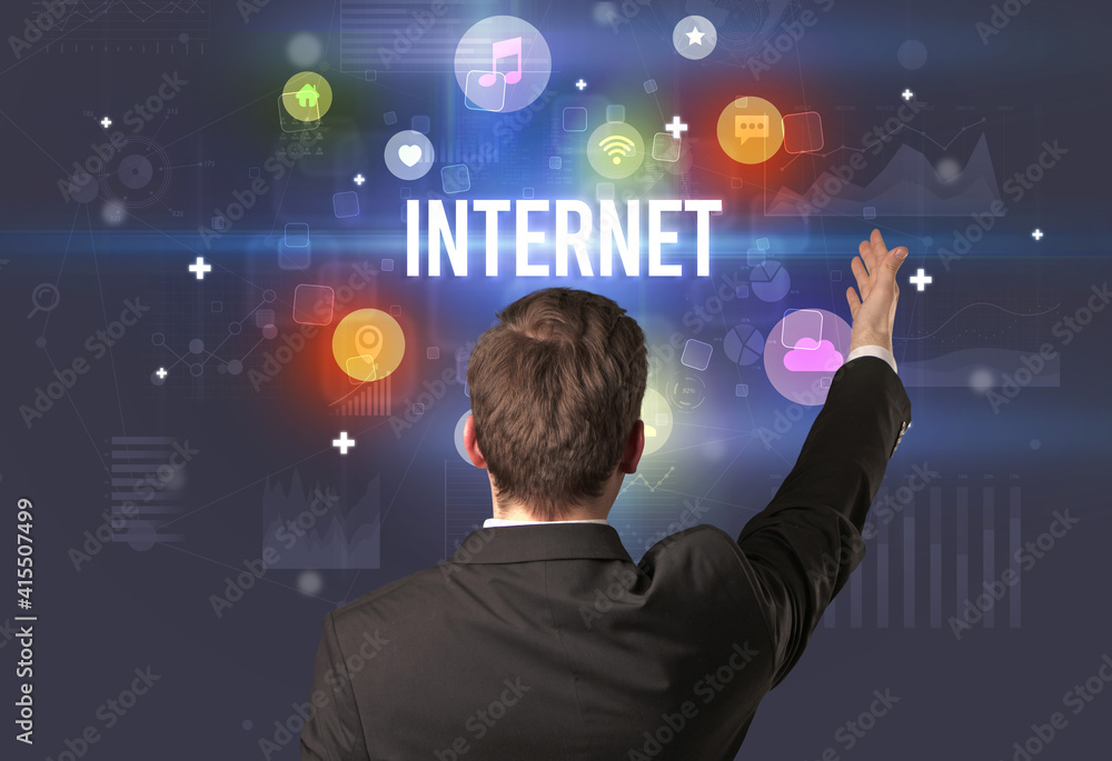 Rear view of a businessman with INTERNET inscription, modern technology concept Rear view of a businessman with INTERNET inscription, modern technology concept