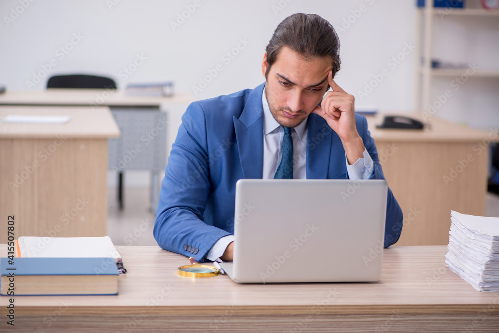Young male employee and too much work in the office Young male employee and too much work in the office