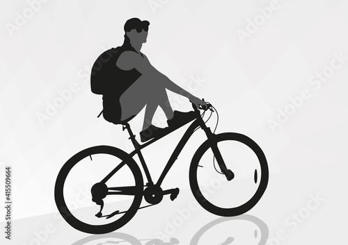 A girl on a bicycle stopped on the road after a long journey