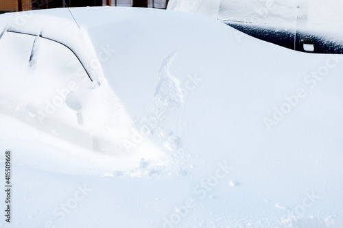 Car buried under a huge snowdrift after snowstorm