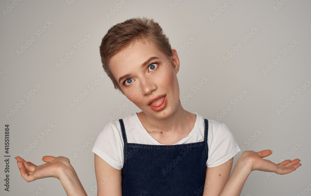 Pretty woman with short hair cosmetics light background Pretty woman with short hair cosmetics light background
