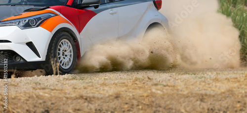 Rally race car drifting on dirt track. photo