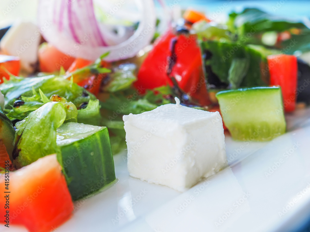 Salad with cucumber and tomato on a blue wooden background Salad with cucumber and tomato on a blue wooden background