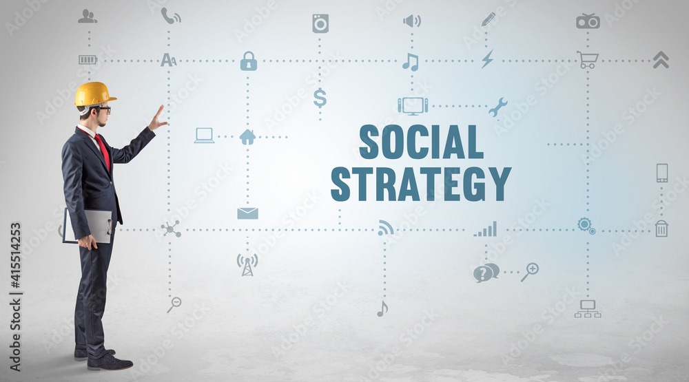 Engineer working on a new social media platform with SOCIAL STRATEGY inscription concept Engineer working on a new social media platform with SOCIAL STRATEGY inscription concept