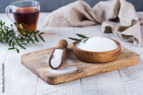 Natural sweetener in a wooden spoon. Sugar substitute. Erythritol photo