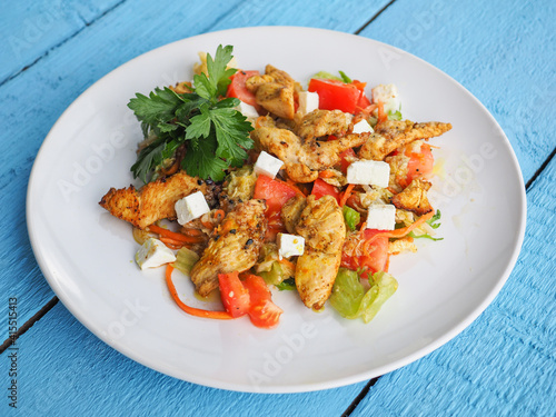 Chicken salad on blue wooden background