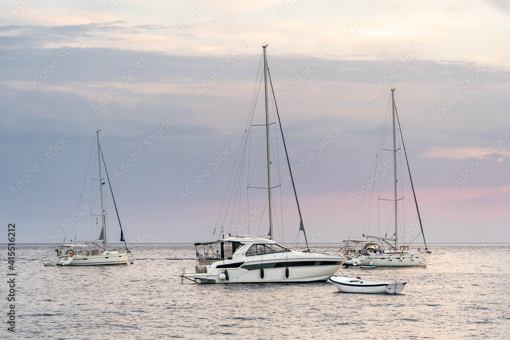 Boats and yachts on adriatic sea in Komiza on vis island in Croatia sunset