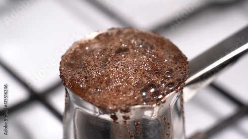 Boiling and overflowing coffee while preparation in turkish coffee pot
