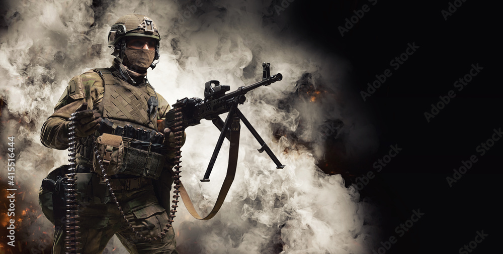 © andy_gin - Special Forces soldier fires a heavy machine gun and holds a band with patroans in his other hand. SWAT concept. © andy_gin - Special Forces soldier fires a heavy machine gun and holds a band with patroans in his other hand. SWAT concept.