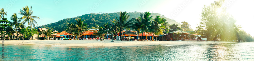 Tropical beach with palm trees and tropical plants and bungalows, tourist vacation Panoramic view of Paradise tropical beach Thailand Banner