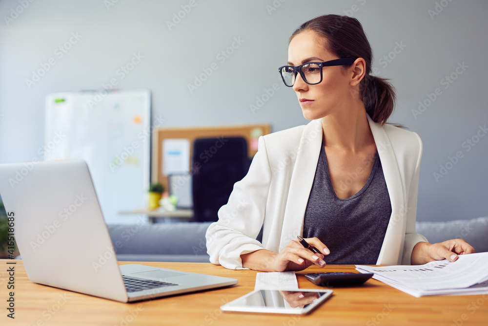 Busy young business woman calculate financial data while working from home office Busy young business woman calculate financial data while working from home office