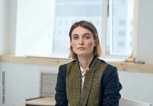 Portrait of a business woman in a suit In a bright room near the window