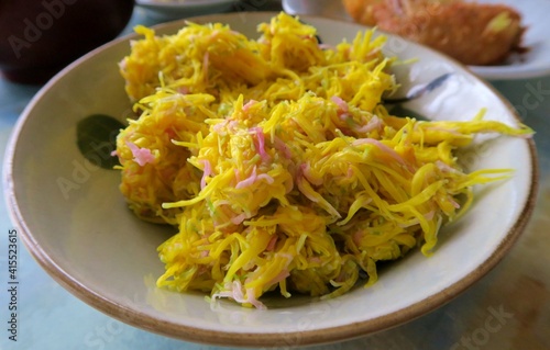 Cooked yellow chrysanthemum called Mottenohoka in a bowl.