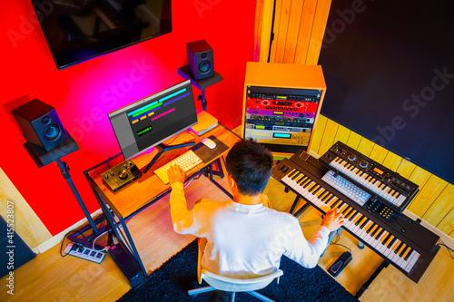 top view of asian male music producer arranging a hit song in home studio photo