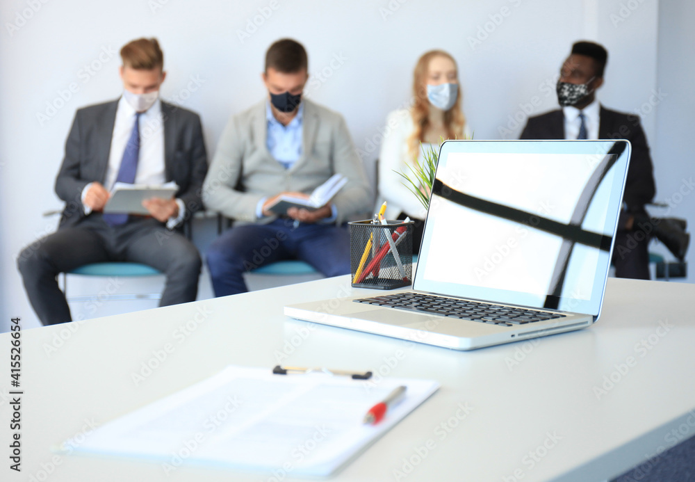 Stressful business people waiting for job interview with face mask, social distancing quarantine during COVID19 affect
