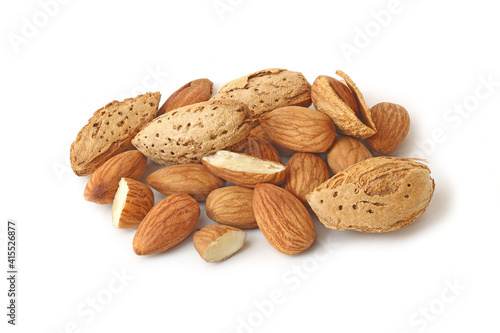 A small heap of almonds in shell and without isolated on the white