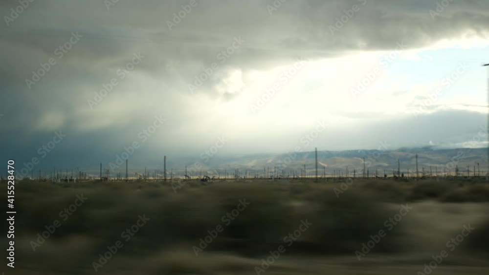 Driving auto, road trip in California, USA, view from car. Hitchhiking traveling in United States. Highway, mountains and cloudy dramatic sky before rain storm. American scenic byway. Passenger POV. Driving auto, road trip in California, USA, view from car. Hitchhiking traveling in United States. Highway, mountains and cloudy dramatic sky before rain storm. American scenic byway. Passenger POV.