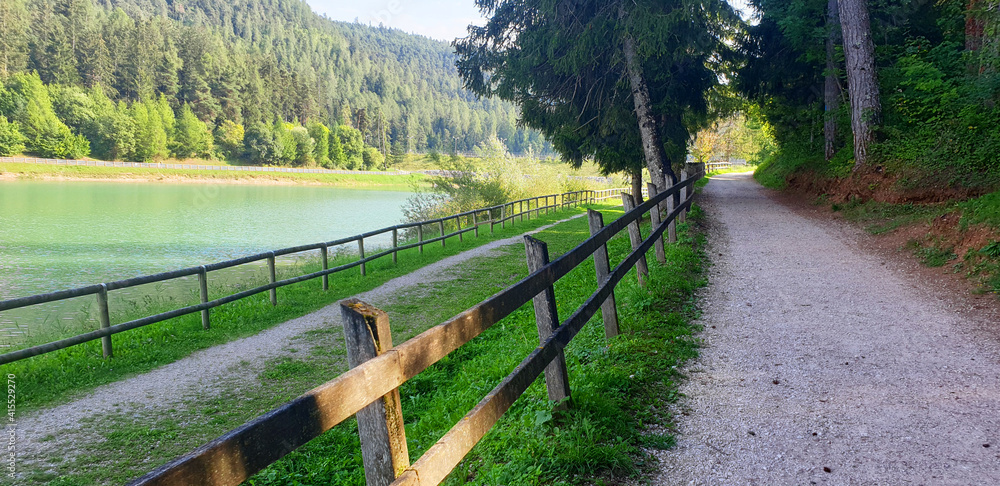 Landscape of Lake Coredo and Tavon with a hiking trail. Panorama of the nature of northern Italy.