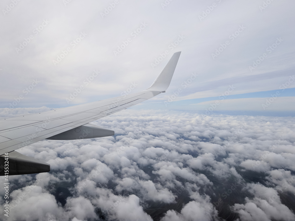 plane flies over cumulus clouds plane flies over cumulus clouds