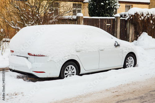 a snow covered car on the side of the street. Riga, Agenskalns 2021 winter