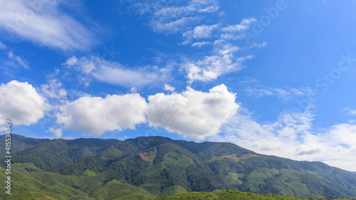 landscape of mountain forest at morning time with blue sky and white cloud.