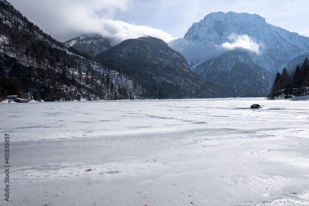 panorama of the frozen Lago del Predil in winter. Italian Alps in Friuli