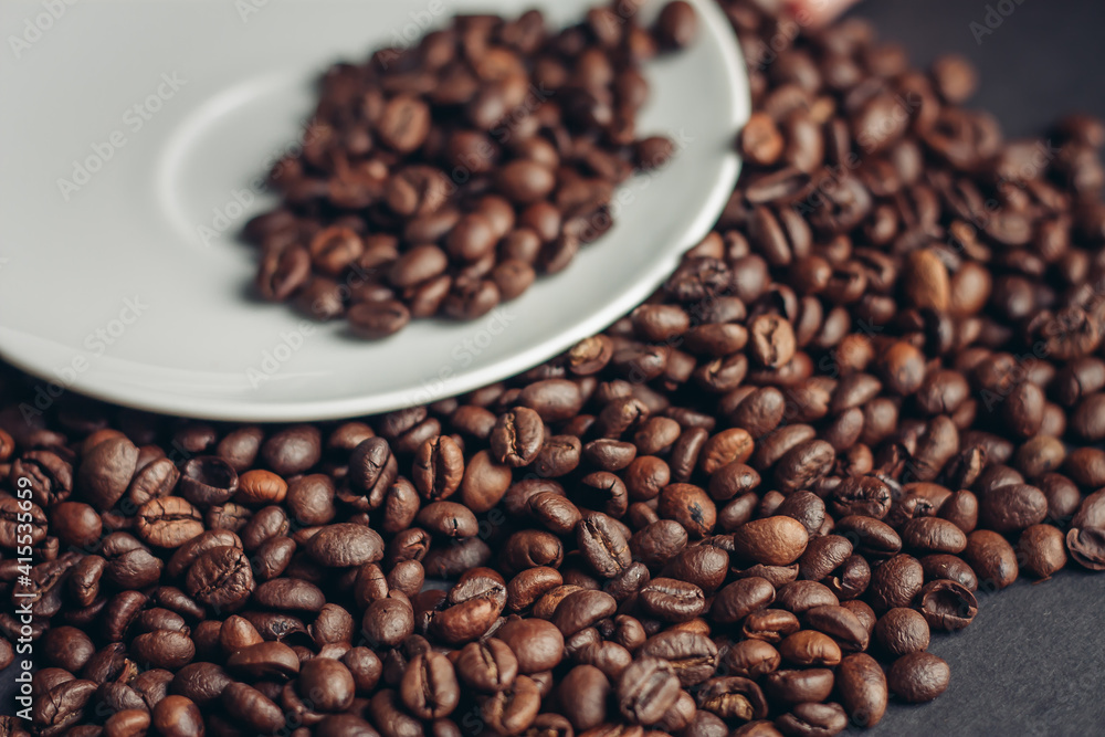 cup of coffee with brown beans on a gray background close-ups macro photography