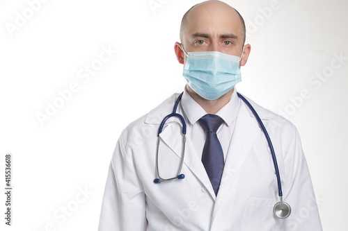 Doctor in Protective Mask with stethoscope and writing pad in hospital