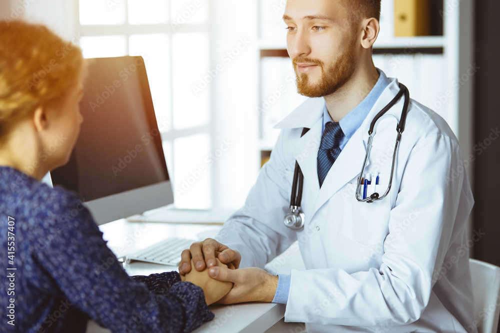 Friendly red-beard doctor reassuring his female patient. Medical ethics and trust concept, medicine theme Friendly red-beard doctor reassuring his female patient. Medical ethics and trust concept, medicine theme
