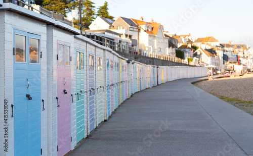 A row of closed and locked up beach huts with no holidaymakers