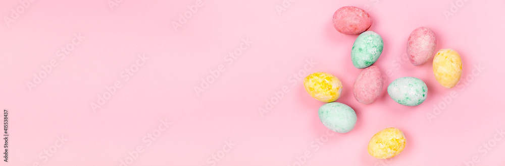 Hand colored easter eggs on light pink abstract background.Top horizontal view copyspace. Happy Easter concept Hand colored easter eggs on light pink abstract background.Top horizontal view copyspace. Happy Easter concept