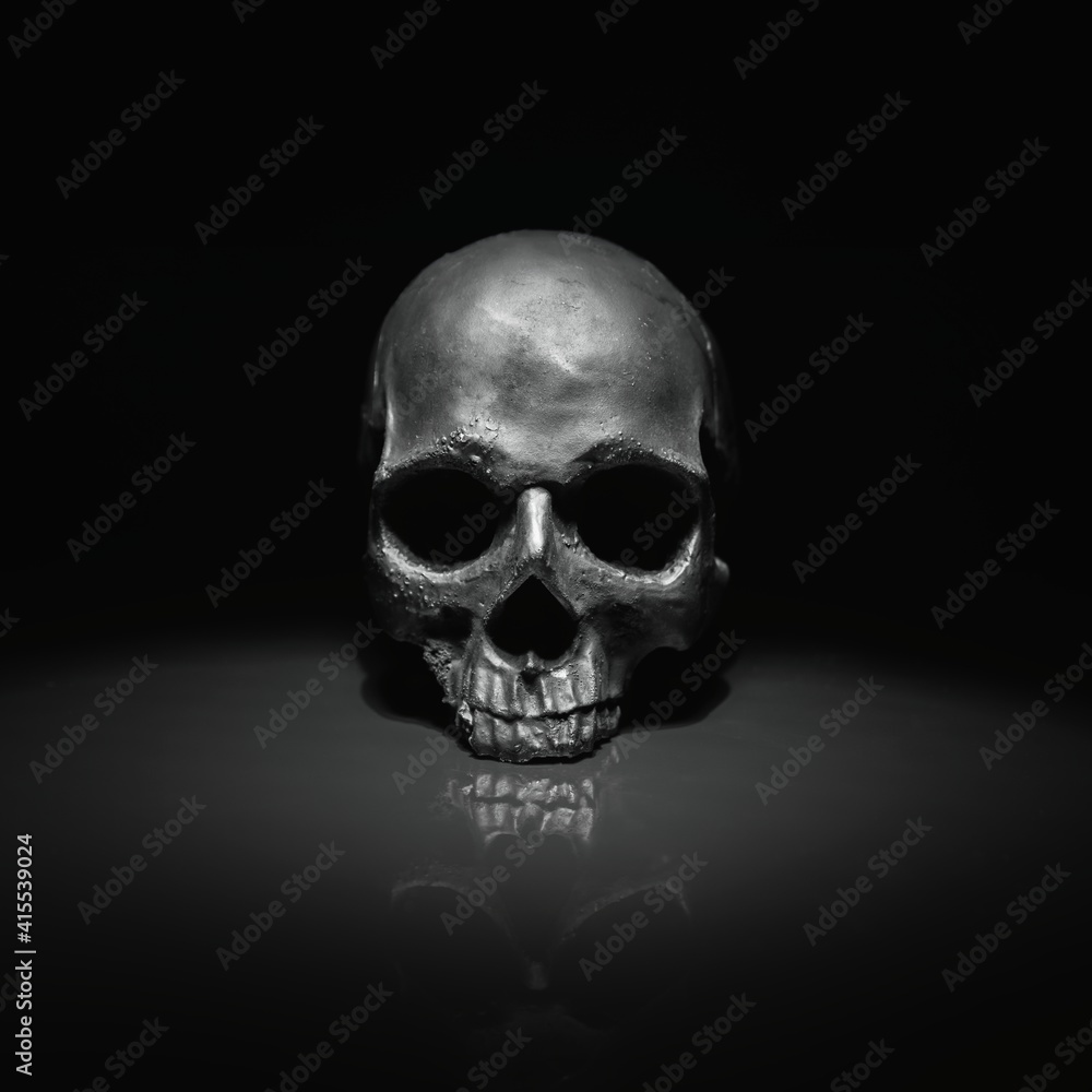 Spooky dark black skull aginast dark background Spooky dark black skull aginast dark background