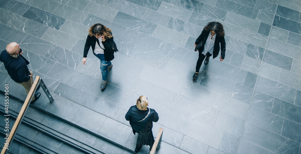 © Jacob Lund - Corporate executives walking across office lobby © Jacob Lund - Corporate executives walking across office lobby