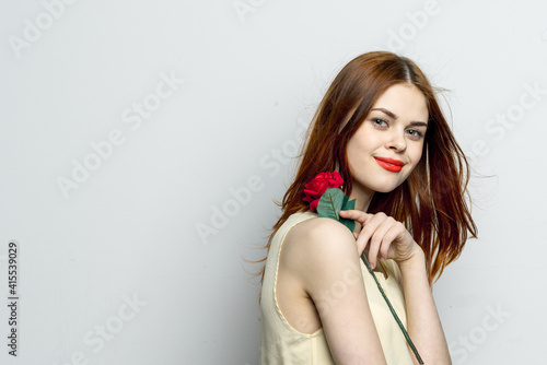 attractive woman with rose flower in hands emotions studio