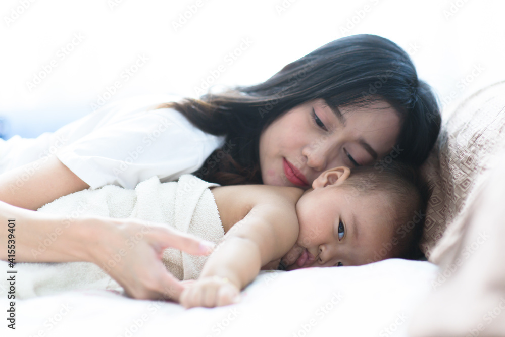 Mom play with baby in a bedroom Mom play with baby in a bedroom