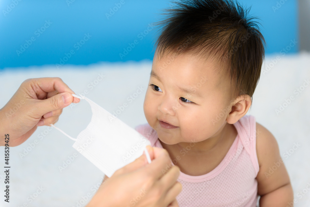 Baby girl wearing surgical mask Baby girl wearing surgical mask
