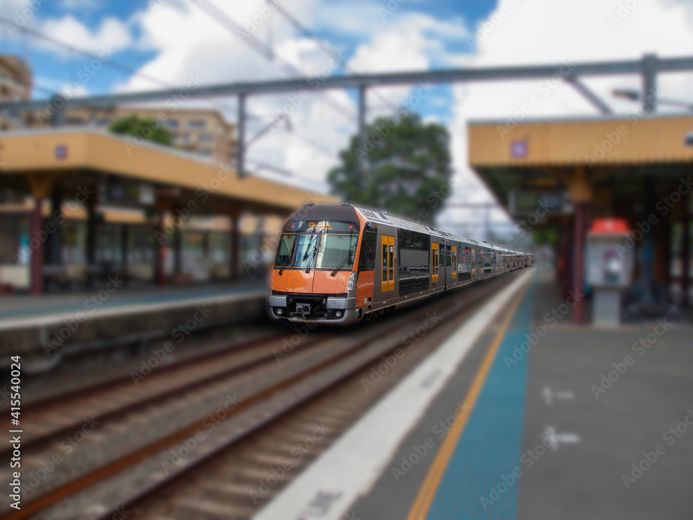 Commuter train approaching train station in Sydney NSW Australia