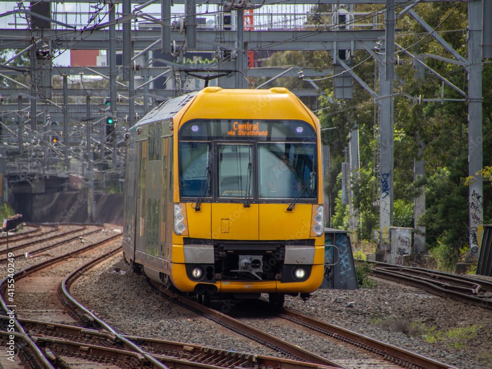 Commuter train approaching train station in Sydney NSW Australia