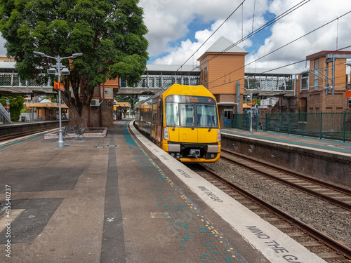 Commuter train approaching train station in Sydney NSW Australia