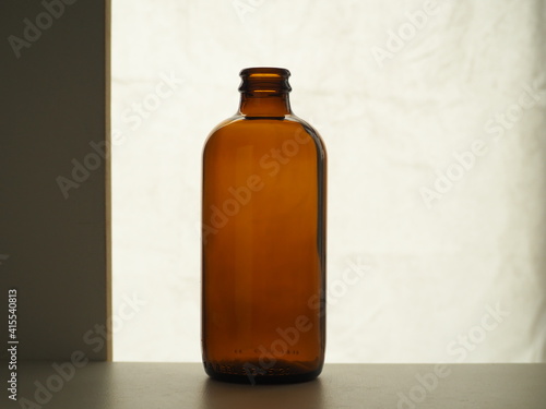 Brown glass bottle on a light background