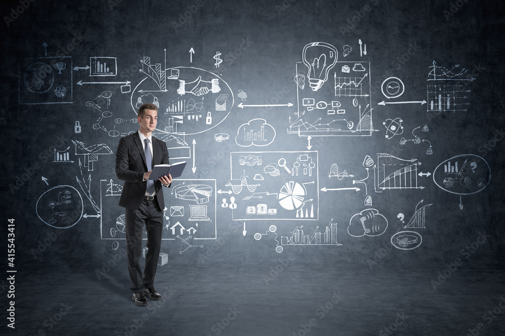 Man with planner standing in concrete room with creative busiene Man with planner standing in concrete room with creative busiene