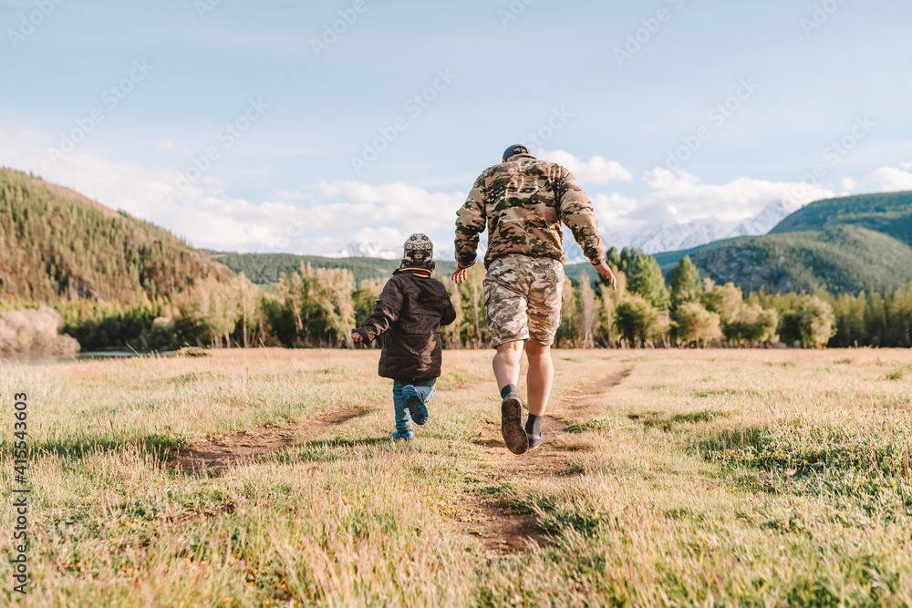 father and son walking outdoors