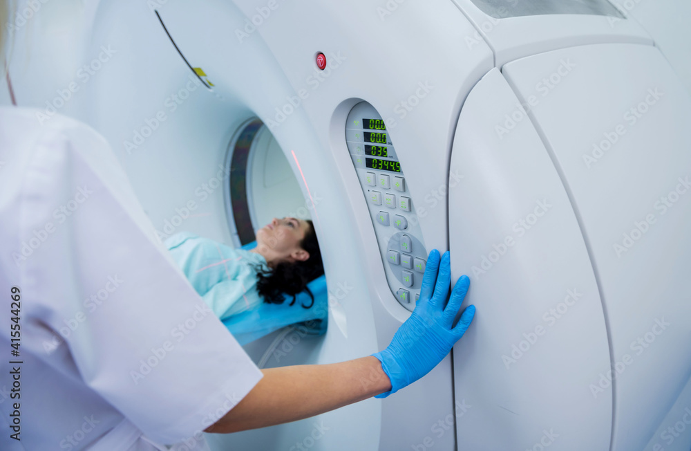 Radiologist with a female patient in the room of computed tomography Radiologist with a female patient in the room of computed tomography