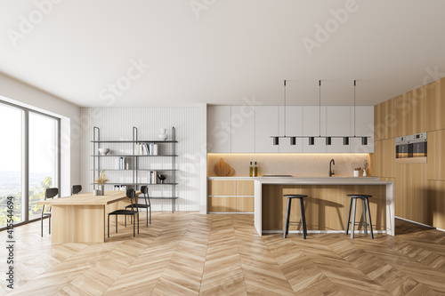 Wooden kitchen room with dining table and chairs, parquet floor photo