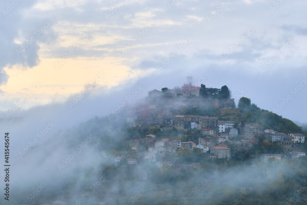 Motovun, Croatia. Motovun hill sorounded by clouds.