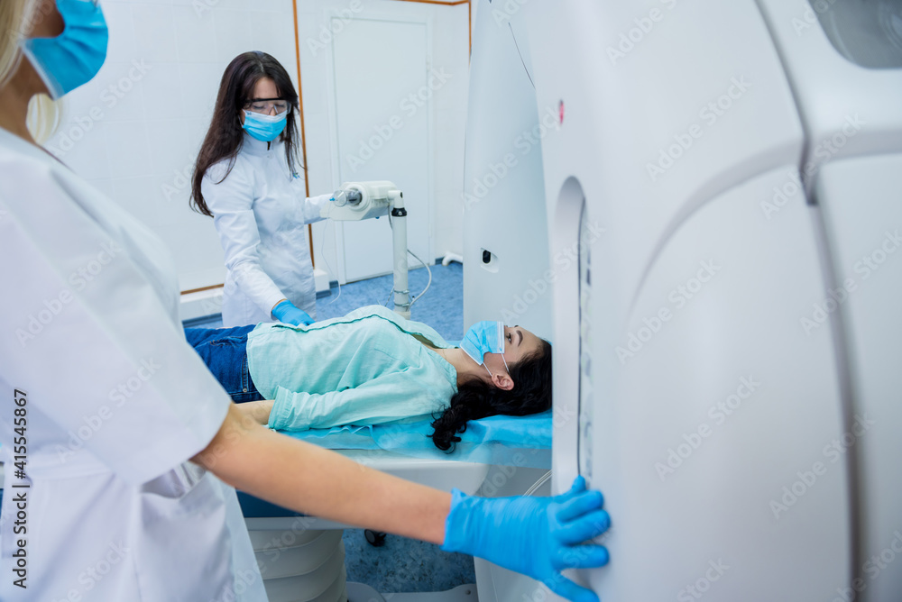 Radiologist with a female patient in the room of computed tomography Radiologist with a female patient in the room of computed tomography