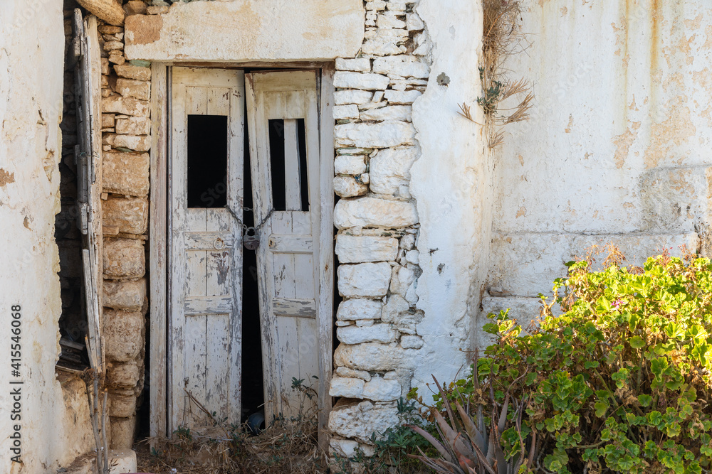 View of the facade of a ruined building in Chora. Folegandros Island, Greece. View of the facade of a ruined building in Chora. Folegandros Island, Greece.