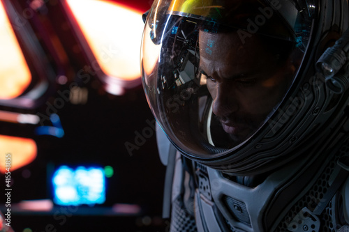 Portrait of African American Black male astronaut inside spaceship cockpit. Sci-fi space exploration concept. Mars mission © supamotion