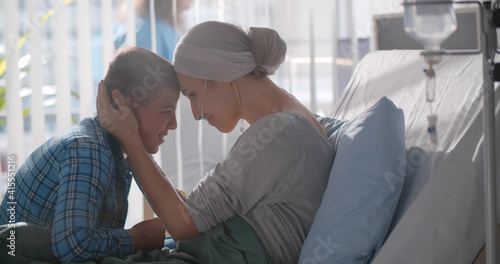 Wallpaper Mural Upset teenage boy embracing sick mother with cancer in hospital Torontodigital.ca