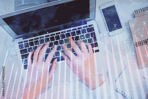 Double exposure of woman hands working on computer and forex chart hologram drawing. Top View. Financial analysis concept.